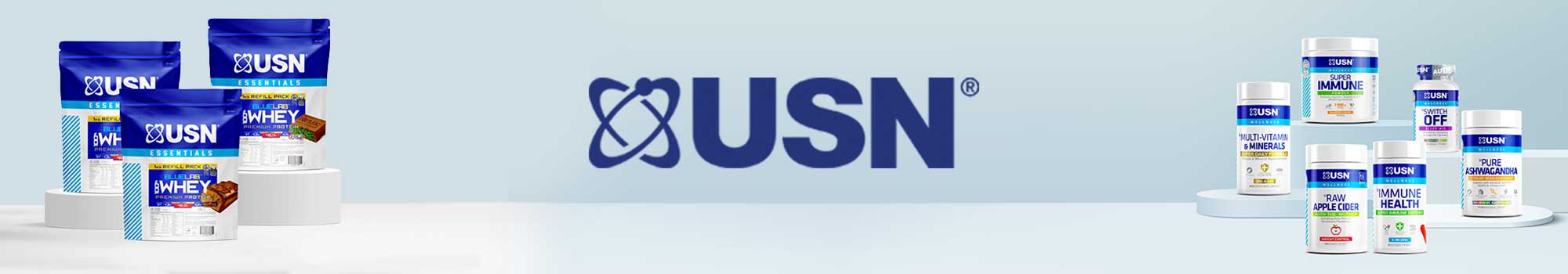 USN nutrition products, including protein powder bags on the left and various supplement bottles on the right, are displayed against a light background with the USN logo in the center.